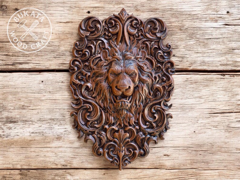 a detailed, intricately carved wooden lion head with a fierce expression, set against a wooden background.