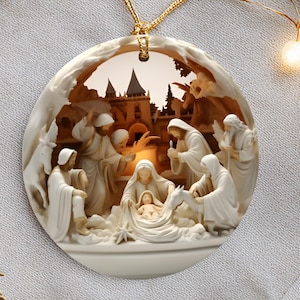 May include: A round, off-white Christmas ornament with a detailed nativity scene. The ornament features figures in flowing robes, a baby in a manger, and a background of a building. A gold-colored string is attached for hanging.