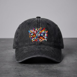 May include: A black denim baseball cap featuring a colorful graphic design with soccer balls, flags, and the text "2026 WORLD CUP". The design is centered on the front of the cap.