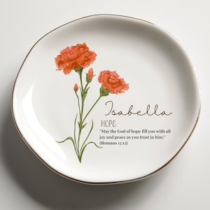 May include: White ceramic plate with a gold rim, featuring orange floral artwork and the name "Isabella." The plate includes the word "HOPE" and a Bible verse from Romans 15:13.