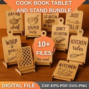 May include: A collection of wooden cutting board-shaped signs with various kitchen-themed phrases and illustrations. The signs include text like "Italian chef," "Don't go bacon," and "Kitchen rules." A wooden tablet stand is also included. The words "Cook Book Tablet and Stand Bundle" are at the top.