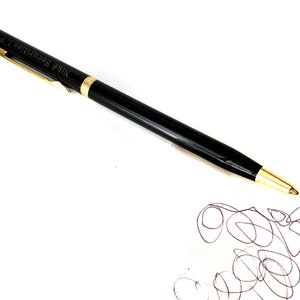 May include: A black pen with gold accents and the inscription "NIKKO Securities LP" on the side.