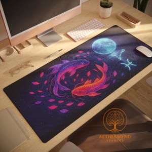 May include: A rectangular mouse mat with a striking design of two koi carp in purple and orange, circling a blue moon and the Pisces zodiac symbol. The mat has a dark blue background with a starry pattern, suitable for a desk.