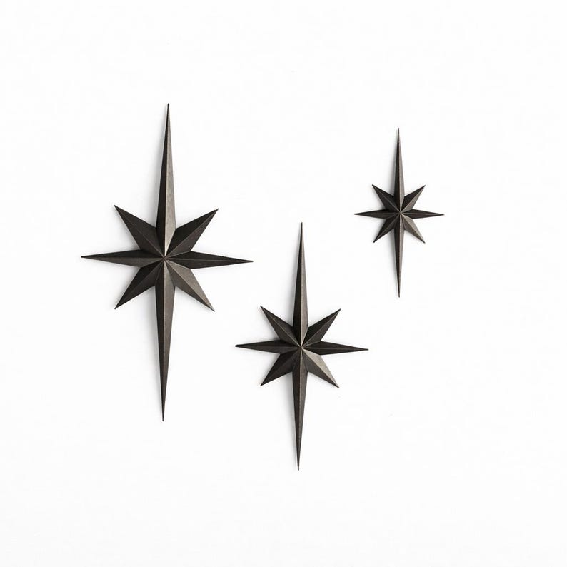 set of three 3 black starburst wall decor pieces different sizes decorative stars Mid Century Starburst Wall Decor Dark Bronze antique gold copper North Star Celestial moon Wall Art Modern Minimal Home Decor bold elegance, modern wall MCM Mid Century starburst North Star sleek dark finish shooting star 3d wall art stylish wall accent wall classic retro Star starry night depth shinny star light premium luxury contemporary moody minimalist Glow in the dark stars brushed brass star brass wall decor