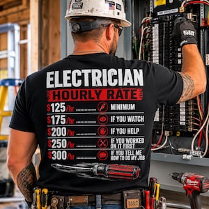 May include: A black t-shirt featuring white and red text that reads ELECTRICIAN HOURLY RATE followed by a list of prices from $125/hr to $300/hr with corresponding icons and conditions, finished with a graphic of a red and black screwdriver.