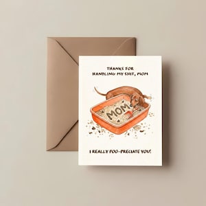 May include: A greeting card with a brown envelope. The card features a dachshund dog in a litter box with the word "MOM" in the litter. The text reads "THANKS FOR HANDLING MY SHIT, MOM" and "I REALLY POO-PRECIATE YOU!"