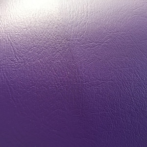 May include: Close-up of a textured purple fabric with a subtle sheen.