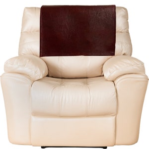 May include: A cream-colored leather recliner with a brown leather armrest cover.