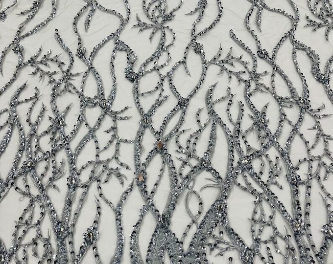 Silver Vine with heavy beading on a mesh lace-sold by the yard.