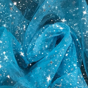 May include: Turquoise blue tulle fabric with silver glitter stars. The fabric is sheer and has a delicate texture.