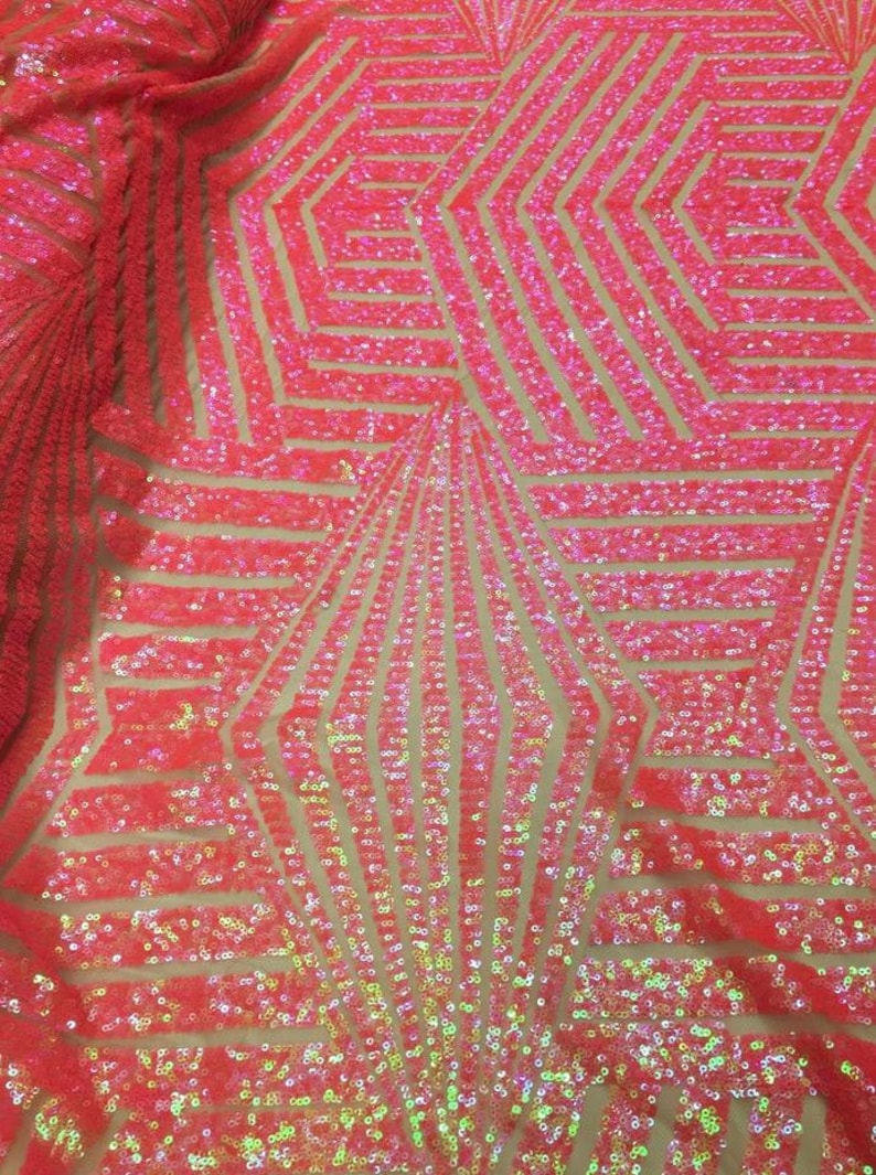 May include: Pink iridescent sequins on a mesh fabric with a geometric pattern. The sequins are arranged in a repeating pattern of lines and shapes.