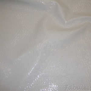 May include: White faux leather fabric with a textured, crocodile-like pattern.