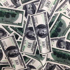 May include: A close-up image of a pile of US $100 bills. The bills are all new and crisp, and they are arranged in a random pattern. The bills are all facing the same direction, and they are all showing the portrait of Benjamin Franklin.