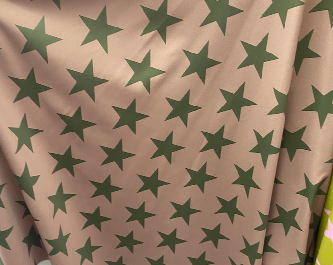 Green stars on camel Spandex trixot 4 way stretch fabric 58" wide