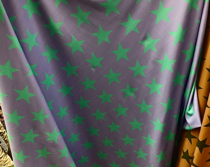 Green stars on black Spandex trixot 4 way stretch fabric 58" wide