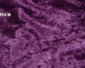 May include: Close-up of a deep purple crushed velvet fabric with a subtle shimmer. The fabric has a soft, plush texture and a luxurious feel.