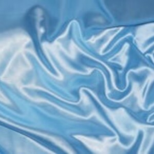 May include: A smooth, light blue satin fabric with soft, flowing folds and wrinkles.