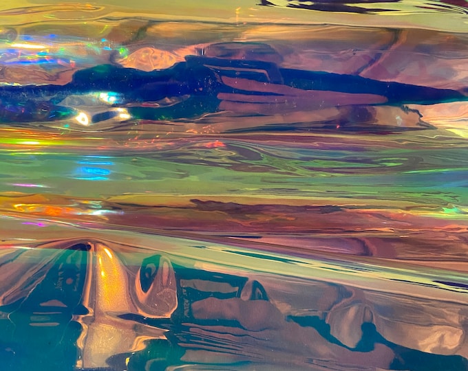 Iridescent clear/reflective 16 gauge illusion non-stretch vinyl . Sold by the YD.