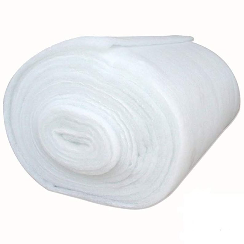 May include: A tightly rolled, white batting material. The roll is composed of layers of soft, fluffy fibers. The material appears to be new and unused, with a clean, bright appearance. The texture suggests it is suitable for quilting or crafting projects.