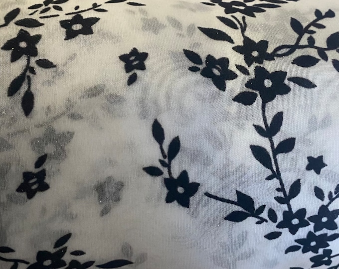 Black floral flocking on white sparkling orgaza fabric 45” wide