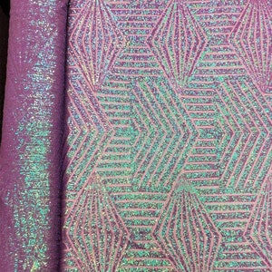May include: Purple iridescent fabric with a geometric pattern of overlapping hexagons and diamonds. The fabric is covered in small sequins that create a shimmering effect.
