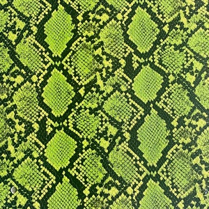 May include: Green and black snakeskin pattern fabric. The pattern is a repeating design of overlapping scales.