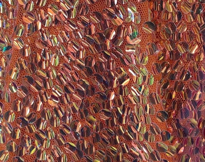 Orange iridescent shiny sequins on a 2 way stretch velvet , sold by the yard