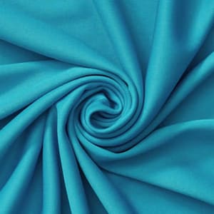 May include: A close-up shot of a turquoise fabric with a swirling pattern. The fabric is soft and flowing, with visible folds and creases. The color is a vibrant, solid turquoise, creating a sense of depth and texture. The fabric appears to be a lightweight material.