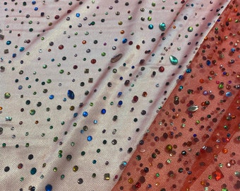 Beaded multicolored, rhinestone gems, on red mesh fabric, 54 inches wide