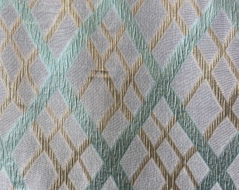 May include: White fabric with a diamond pattern in gold and light blue.