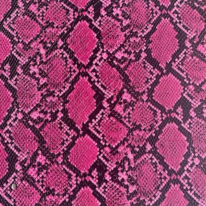 May include: Pink snakeskin patterned fabric with a textured surface.