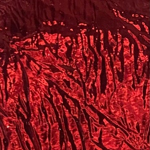 May include: Red metallic fabric with a wrinkled, textured surface. The fabric has a dark, almost black, sheen in some areas.