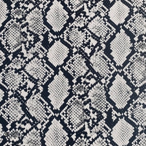 May include: Black and white snakeskin pattern fabric. The pattern is a repeating design of scales.