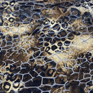 May include: A brown and gold fabric with a leopard print and a geometric pattern.