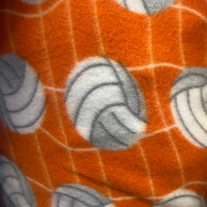 Volleyball Fleece on orange 60” wide By The Yard