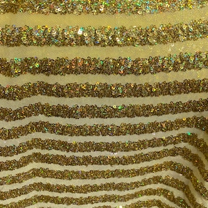 May include: Yellow fabric with horizontal stripes of gold sequins.