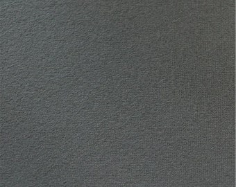 May include: A close-up of a dark gray fabric with a textured surface.