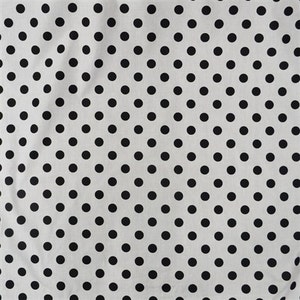 May include: White fabric with a black polka dot pattern. The dots are evenly spaced and cover the entire surface of the fabric.