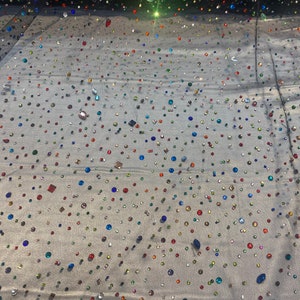 Beaded multicolored, rhinestone gems, on black mesh fabric, 54 inches wide