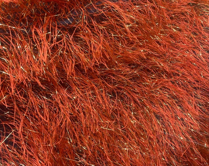 Orange feather tinsel on mesh fabric per yard 60" wide