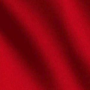 May include: A solid, vibrant red fabric with a smooth, uniform texture. The material features soft, diagonal folds and subtle shadows that create a gentle, flowing appearance across the surface, highlighting the deep, consistent crimson color.