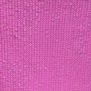 May include: A close-up of a pink fabric with a sequined pattern. The sequins are small and round, and they are arranged in a regular pattern.