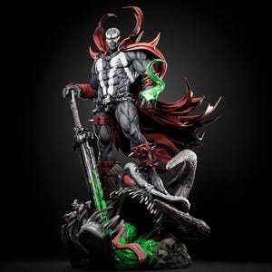 May include: A detailed statue of Spawn, a comic book character, stands on a detailed base. The figure is predominantly gray and black, with a red cape and accents. He holds a large sword with green accents and a green energy effect.