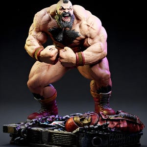 May include: A muscular figurine of a man with a mohawk, beard, and red wristbands, posed in a fighting stance. The figure is standing on a detailed base with a defeated opponent. The color palette includes shades of tan, red, and black.