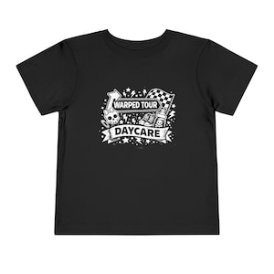 May include: Black toddler t-shirt with a white graphic. The graphic includes the words "Warped Tour Daycare" with a skull, arrow, checkered flag, baby bottle, and sneakers.
