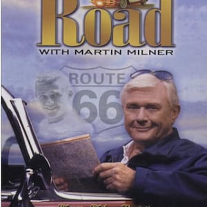 May include: A DVD cover titled Route 66 Return to the Road with Martin Milner. It features a red vintage car, a man with white hair wearing sunglasses on his head, and a ghostly image of a younger man holding a map against a Route 66 sign background.