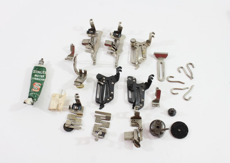 Vintage Singer and Simanco sewing attachments with box. Includes unmarked attachments as well.