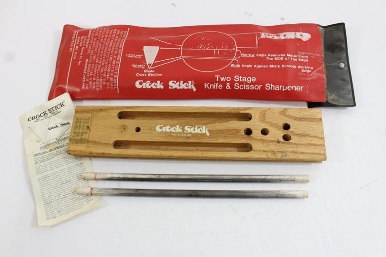 This is a knife and scirrors sharpener, a patented set called a Crock Stick from the 70s which features 2 whetstone rods that fit into a wooden holder. Complete instructions with diagrams included.