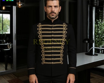 May include: Black military-style jacket with gold trim and button details. The jacket features a high collar and is worn with black pants. The text "REGENCY FASHION" is visible on the jacket. The letters "TRF" are in the upper left corner.