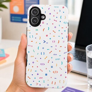 May include: A white smartphone case featuring a colorful pattern of programming symbols, including brackets, mathematical operators, binary numbers, and the text 'else' and 'if' scattered across the surface in shades of blue, orange, and purple.